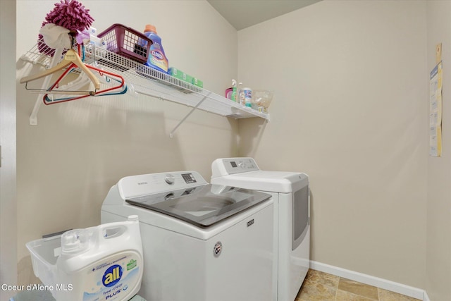 washroom with washer and dryer, laundry area, and baseboards