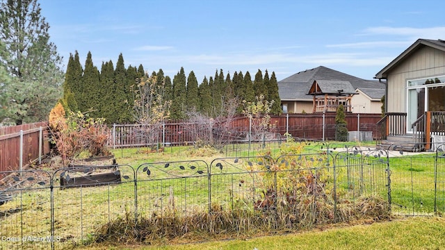 view of yard featuring a garden and a fenced backyard