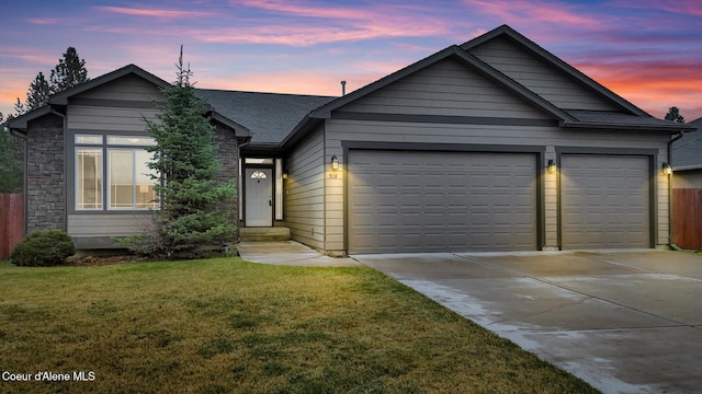 ranch-style home featuring a shingled roof, a front lawn, a garage, stone siding, and driveway