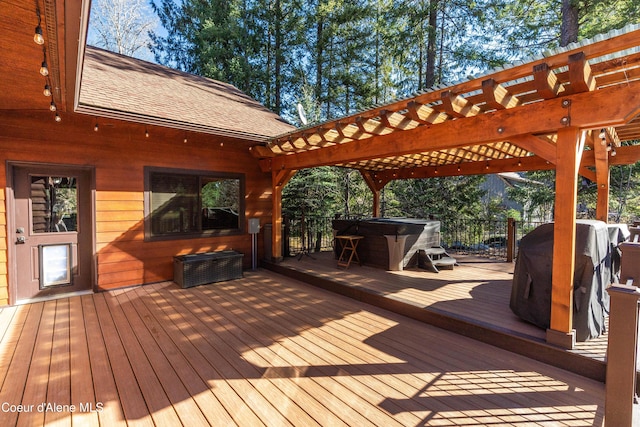 wooden terrace featuring area for grilling, a jacuzzi, and a pergola