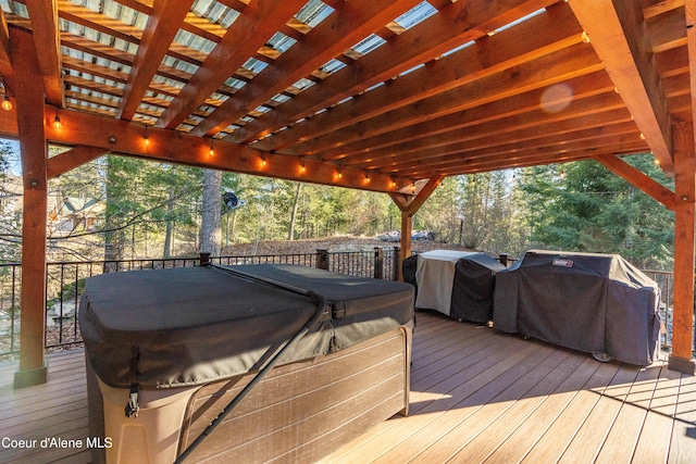 wooden deck featuring a grill and a hot tub