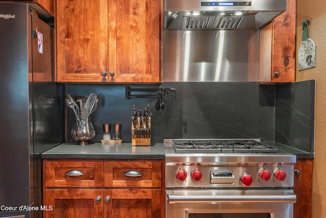 kitchen with stainless steel appliances, decorative backsplash, and brown cabinetry