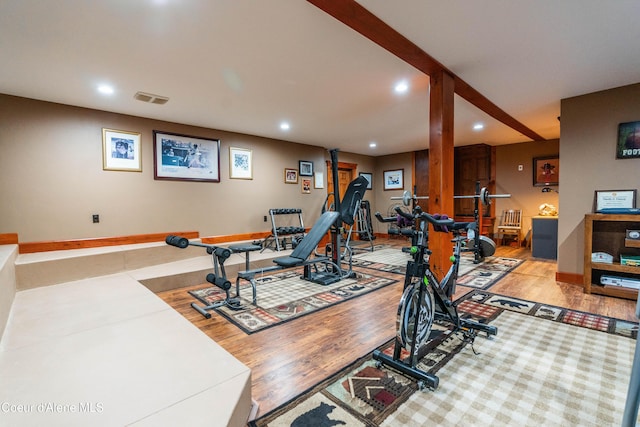 workout area featuring recessed lighting, visible vents, baseboards, and wood finished floors