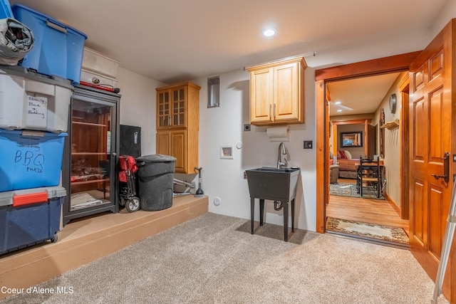 clothes washing area with recessed lighting and carpet floors