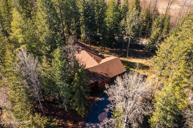 drone / aerial view with a wooded view