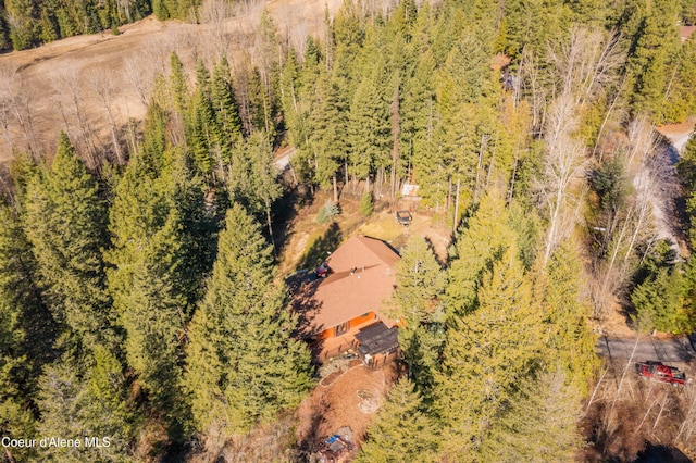 drone / aerial view featuring a wooded view