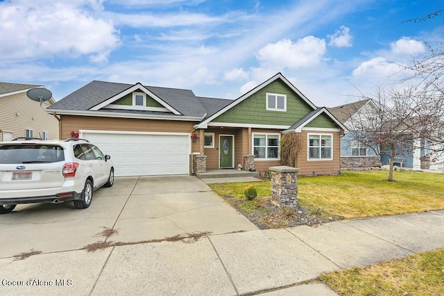 craftsman-style home featuring an attached garage, concrete driveway, and a front lawn