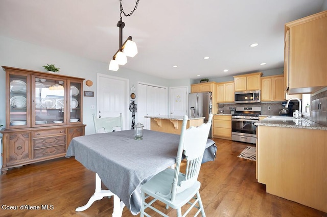 dining area featuring recessed lighting and wood finished floors