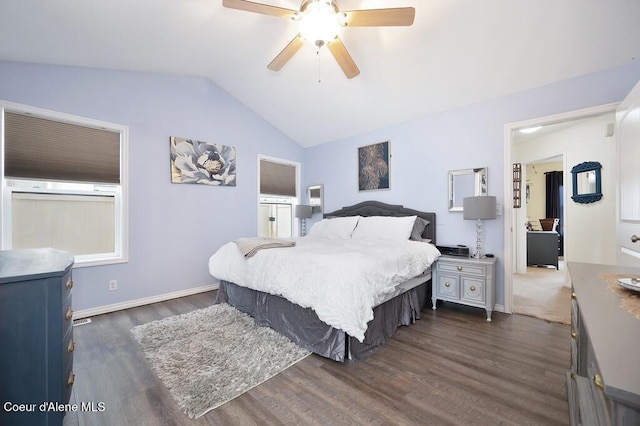 bedroom with baseboards, ceiling fan, dark wood-style flooring, and vaulted ceiling