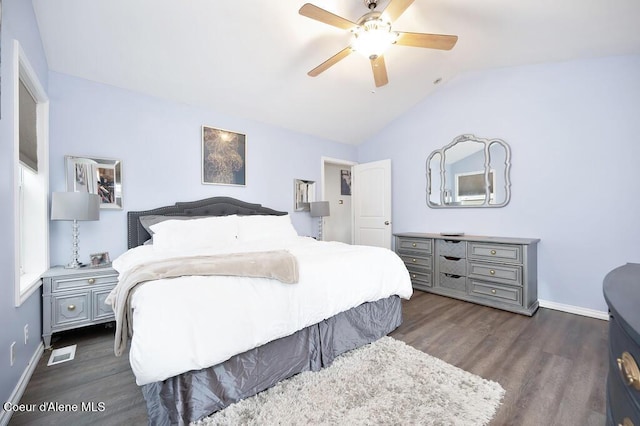 bedroom with visible vents, baseboards, dark wood finished floors, lofted ceiling, and a ceiling fan