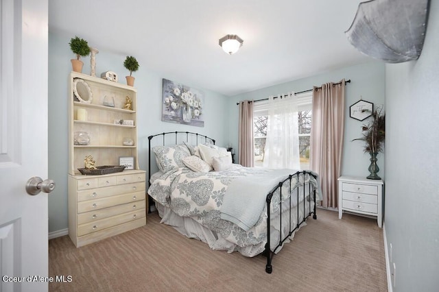 bedroom featuring light carpet and baseboards