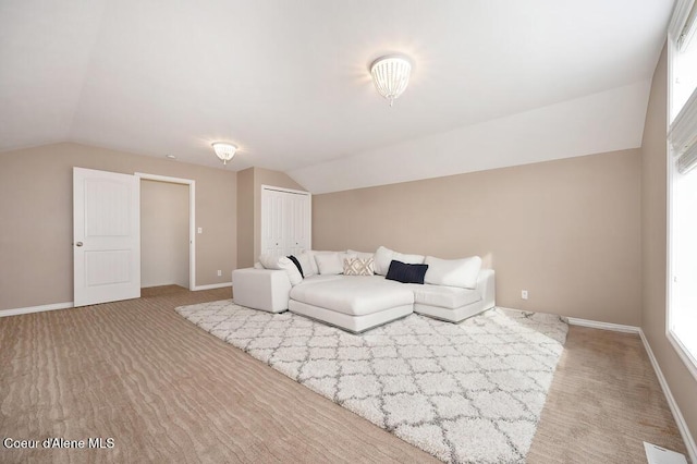 living room with vaulted ceiling and baseboards