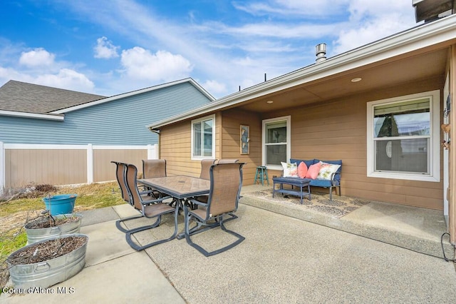 view of patio featuring outdoor dining space and fence