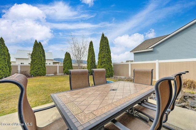 view of patio with a fenced backyard and outdoor dining space