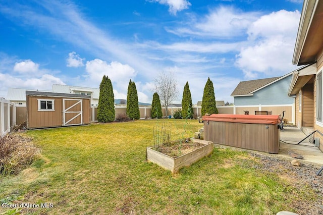 view of yard with a garden, a fenced backyard, a hot tub, an outdoor structure, and a storage shed