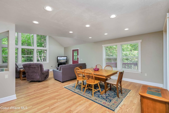 dining space with recessed lighting, baseboards, light wood-style floors, and vaulted ceiling