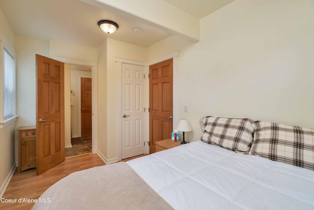 bedroom featuring baseboards and wood finished floors