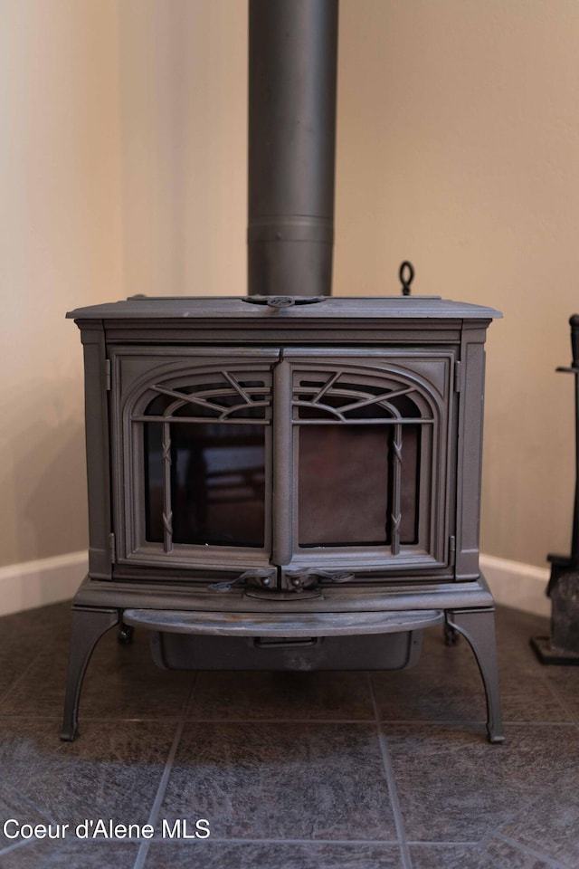 details with baseboards and a wood stove