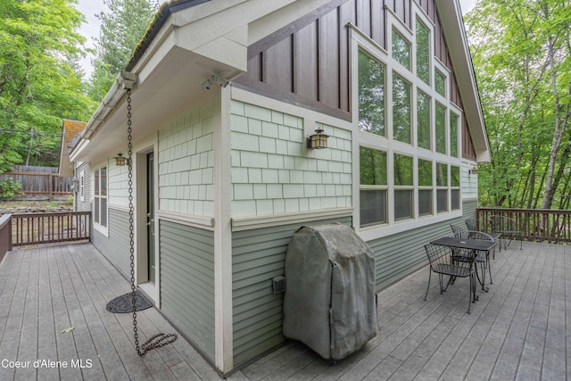 deck featuring grilling area and fence