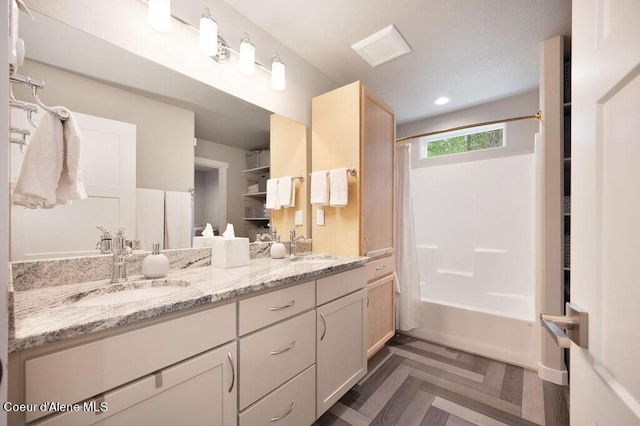 full bathroom with a sink, shower / bath combo with shower curtain, recessed lighting, and double vanity