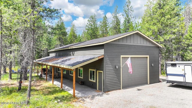 exterior space featuring gravel driveway and a garage