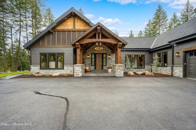 craftsman-style home featuring stone siding and board and batten siding