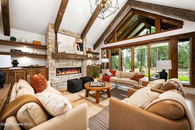 living area featuring beamed ceiling, a fireplace, an inviting chandelier, wood finished floors, and high vaulted ceiling