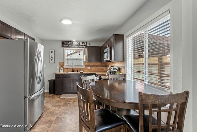 dining space with baseboards and a textured ceiling