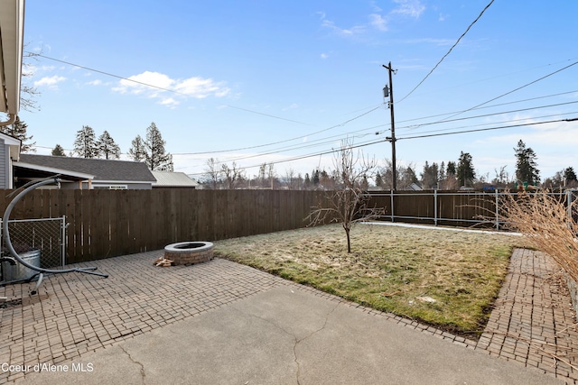 view of yard with a patio, a fire pit, and a fenced backyard