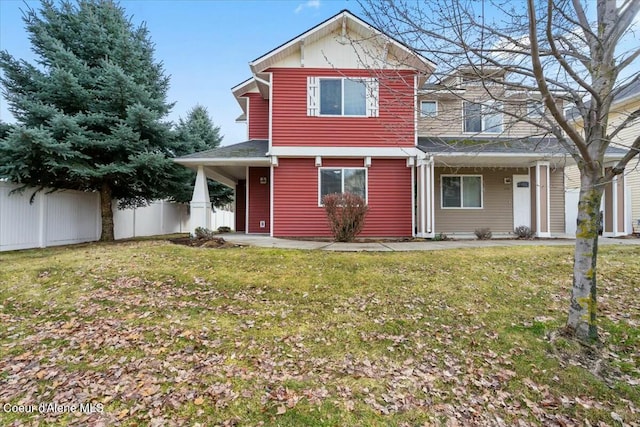 view of front facade featuring a front yard and fence