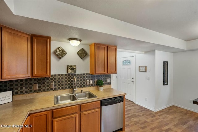 kitchen with light wood finished floors, a sink, dishwasher, tasteful backsplash, and brown cabinets