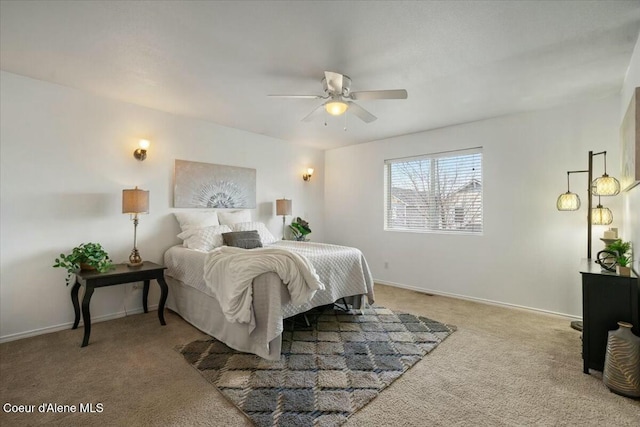 carpeted bedroom with ceiling fan and baseboards