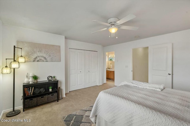 bedroom featuring a closet, light carpet, baseboards, and ceiling fan