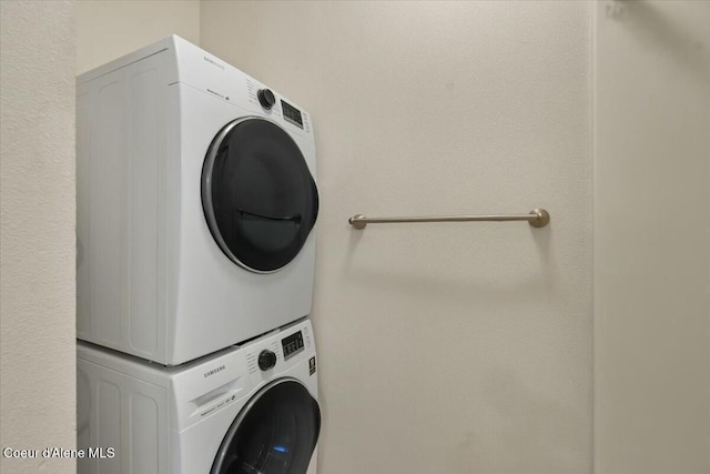 laundry area with stacked washer / drying machine and laundry area