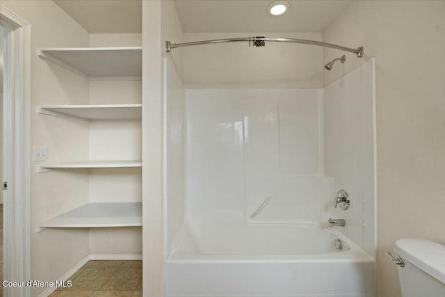 full bathroom featuring tile patterned floors, toilet, tub / shower combination, and baseboards