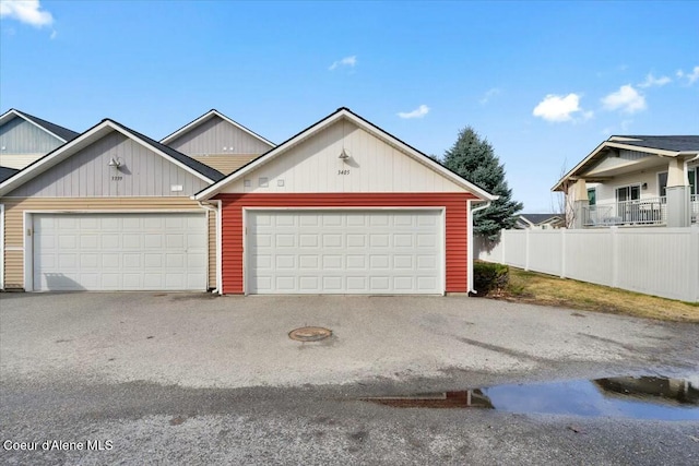 garage with driveway and fence