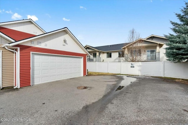 exterior space featuring driveway and fence