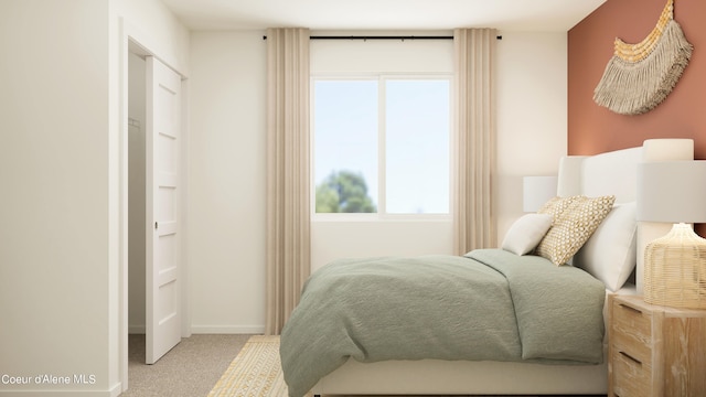 carpeted bedroom featuring baseboards