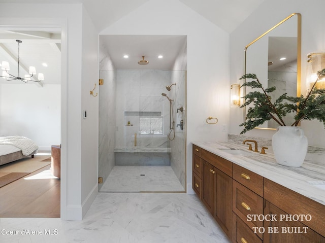 ensuite bathroom with connected bathroom, a stall shower, marble finish floor, and an inviting chandelier