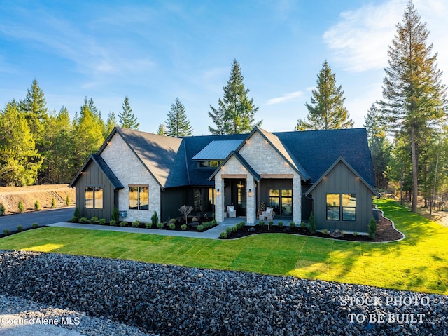 view of front of house with stone siding, board and batten siding, and a front lawn