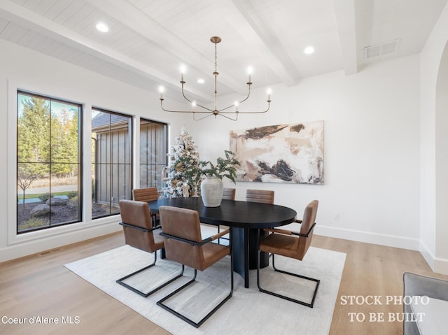 dining room featuring visible vents, beamed ceiling, light wood-style floors, an inviting chandelier, and baseboards