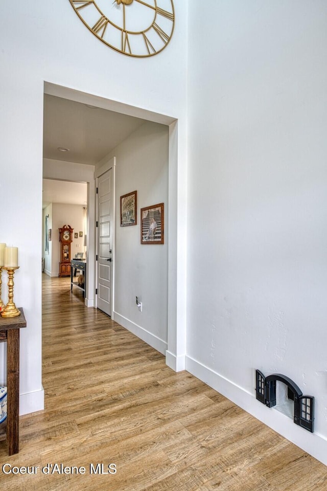 hall featuring baseboards and wood finished floors