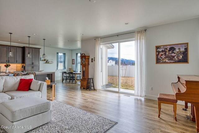 living area featuring light wood finished floors and baseboards