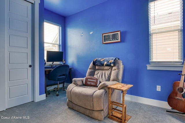 carpeted office space featuring baseboards