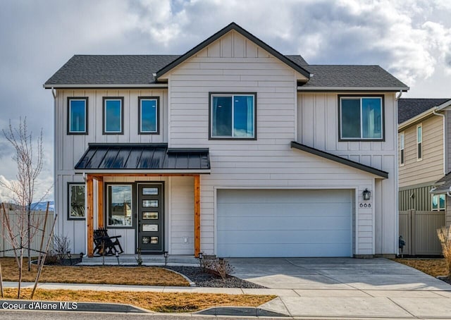 view of front facade featuring a standing seam roof, concrete driveway, a garage, board and batten siding, and metal roof