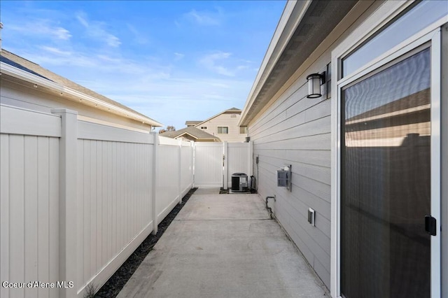 view of patio featuring central air condition unit and fence