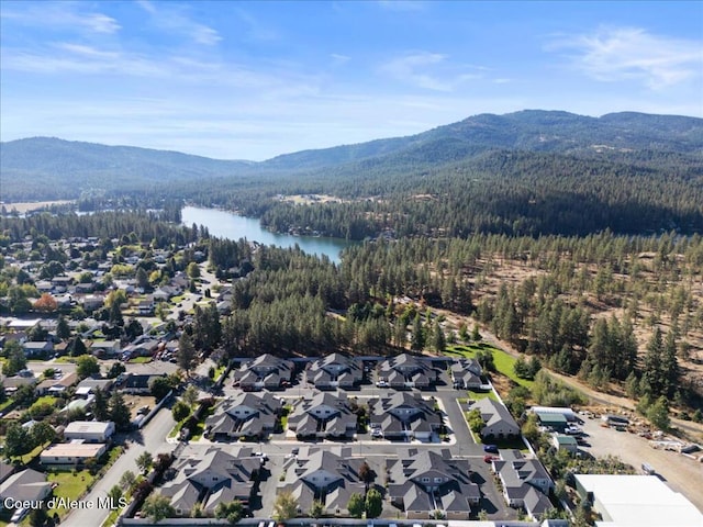 bird's eye view with a view of trees, a residential view, and a water and mountain view