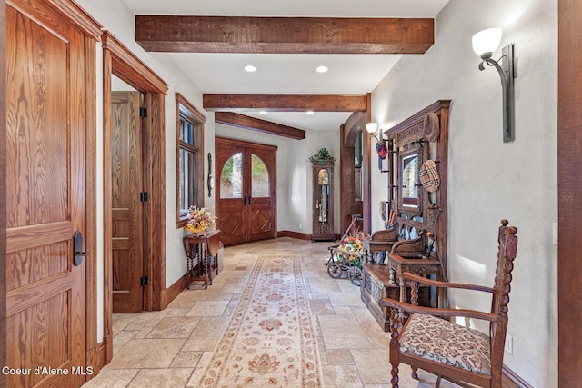 entrance foyer with beam ceiling, recessed lighting, baseboards, and stone tile flooring