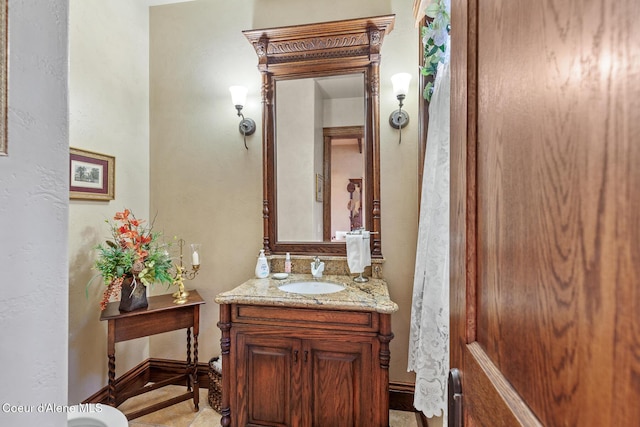 bathroom featuring vanity and baseboards