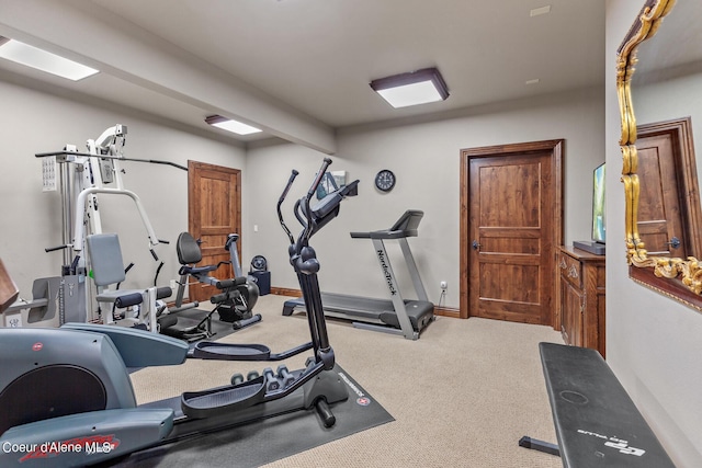 workout room with carpet flooring and baseboards